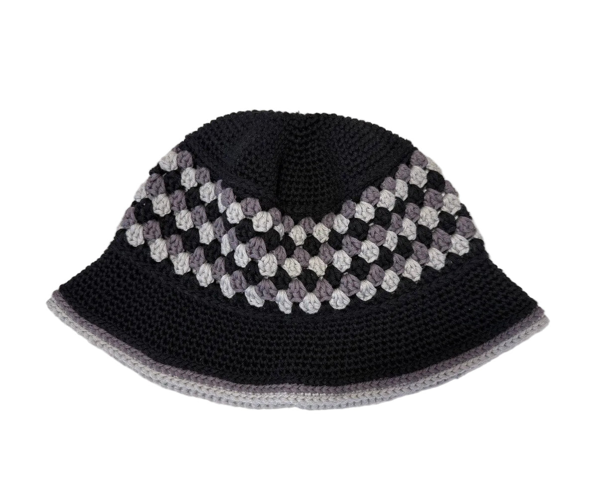 A black/grey crocheted bucket hat on a white background