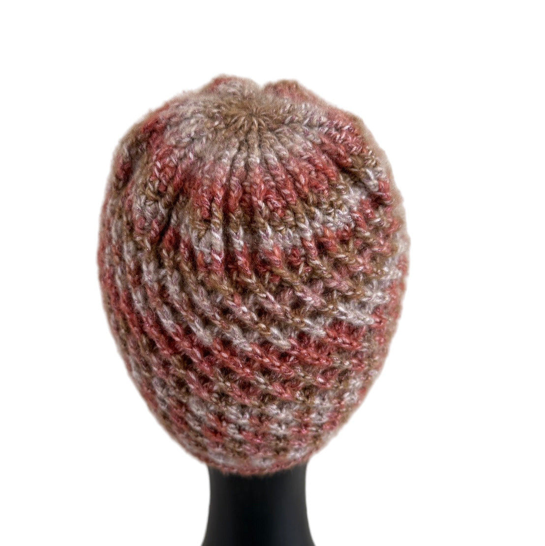 A handmade crochet spirograph beanie in red, brown, and beige shades displayed on a mannequin head.