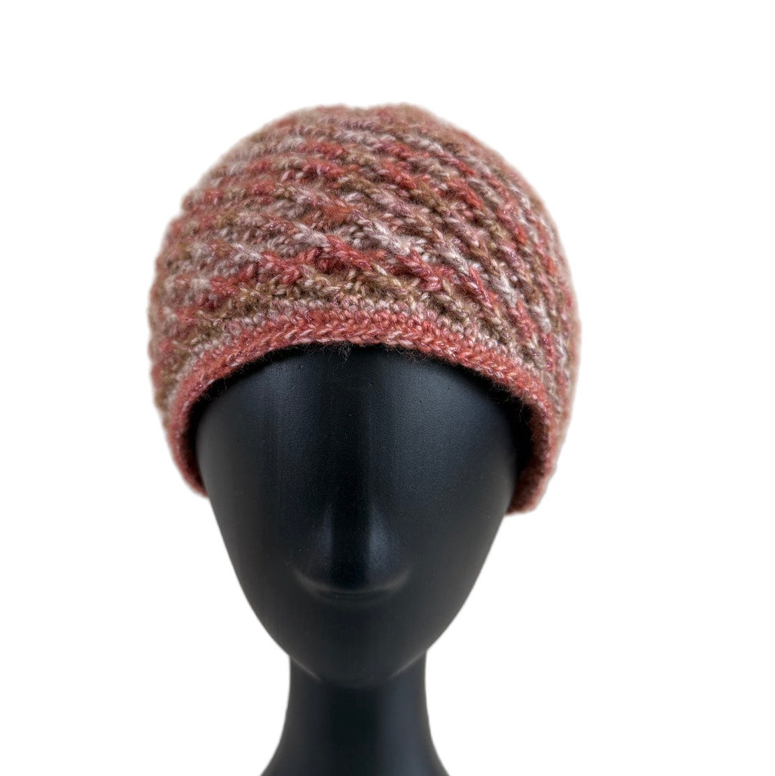 A handmade crochet spirograph beanie in red, brown, and beige shades displayed on a mannequin head.