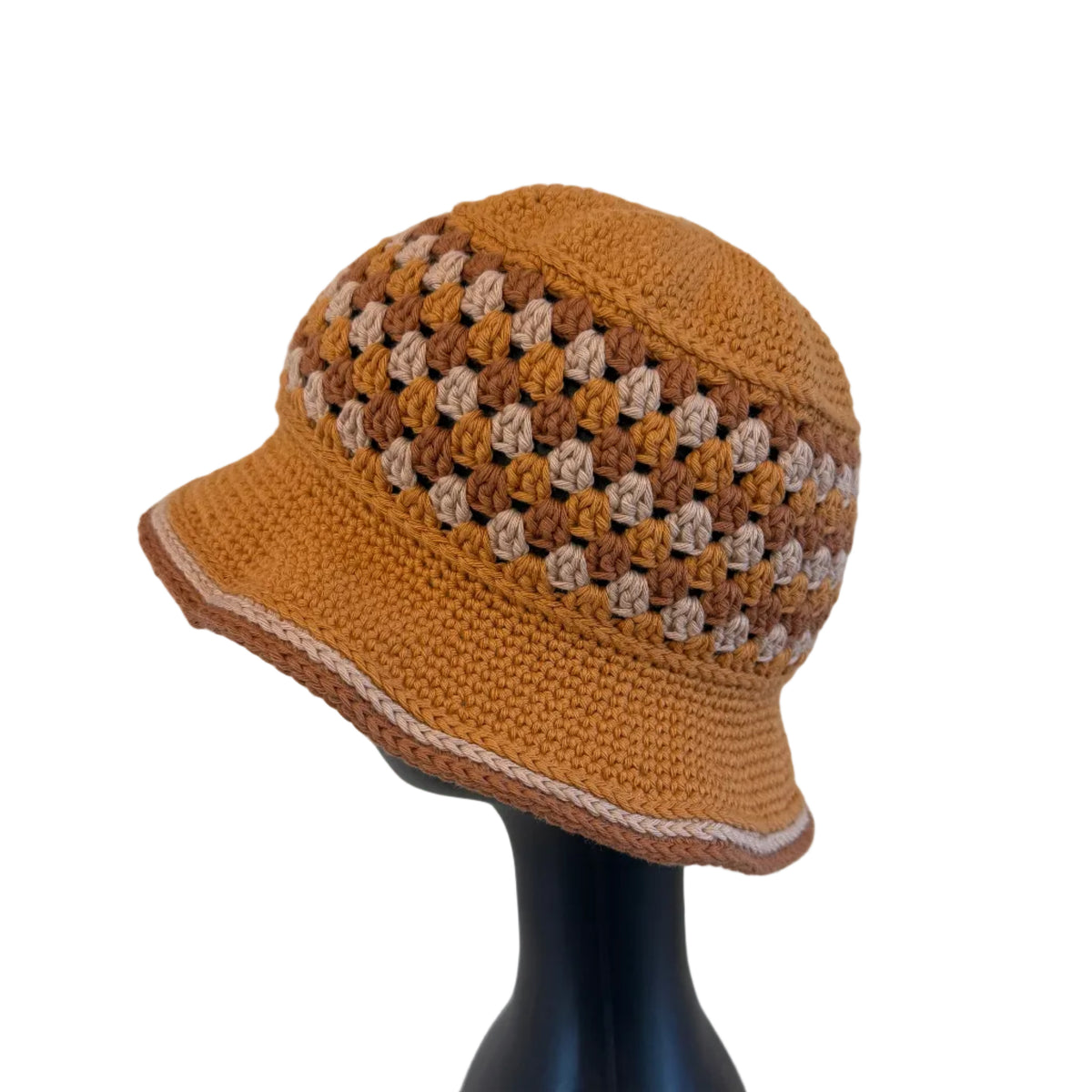 A gold/brown crocheted bucket hat displayed on a black mannequin head on a white background