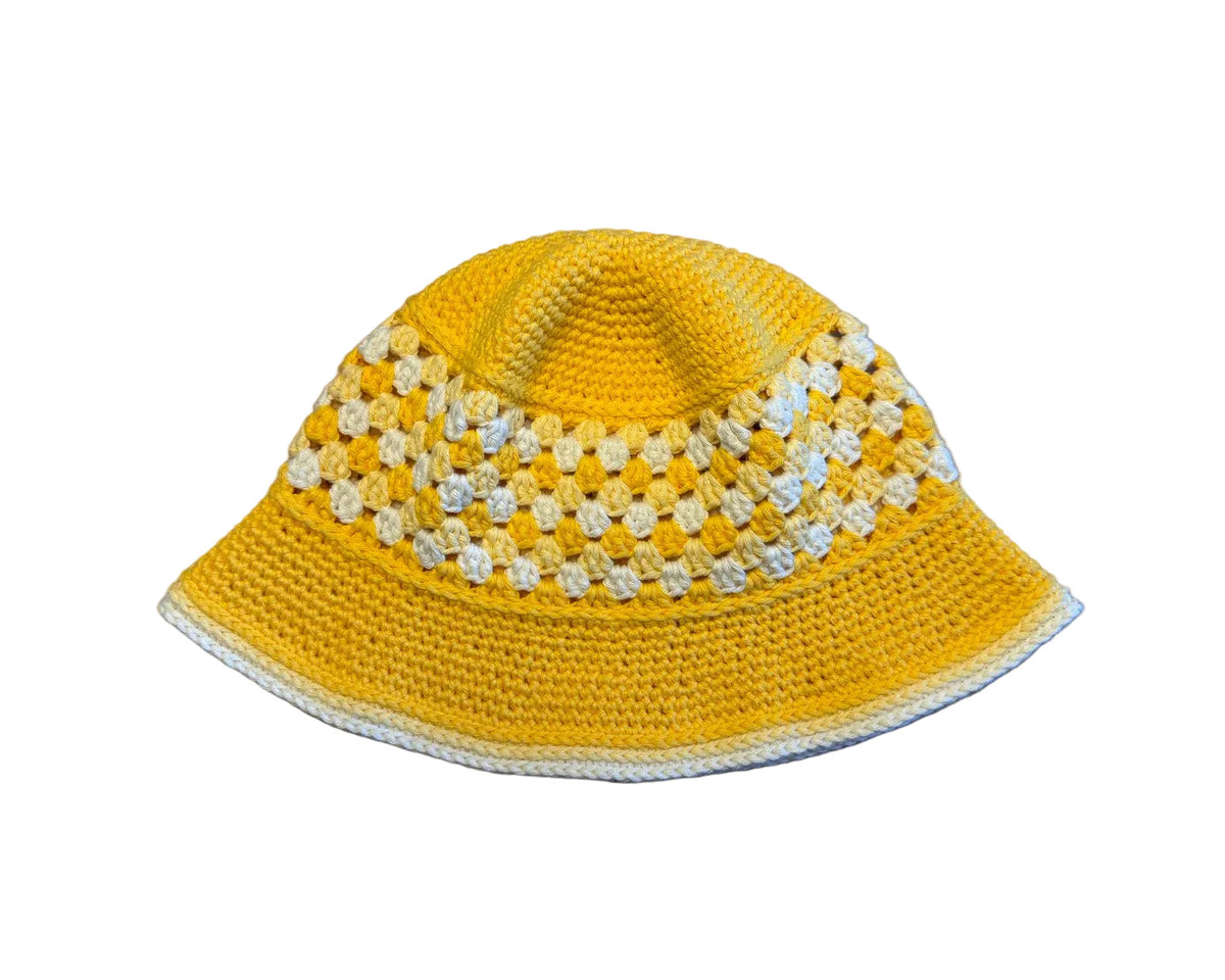 A yellow crocheted bucket hat on a white background